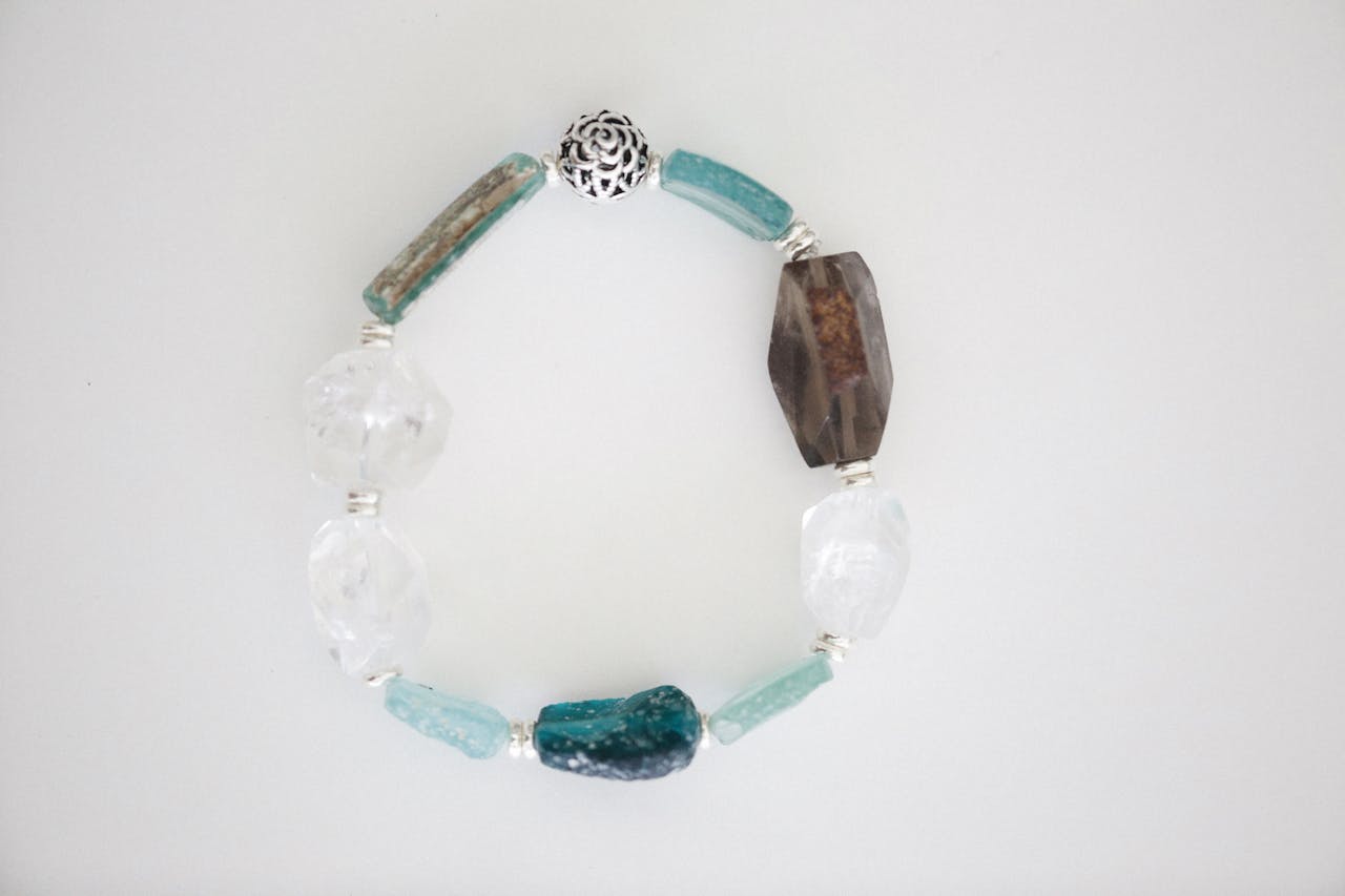 A stylish gemstone bead bracelet featuring various stones on a white background.